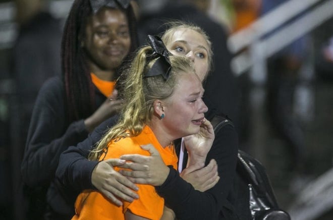 Emilie Cornelius, 14, center is comforted during he Freeport-Auburn football game on Friday that came to a sudden end when gunfire rang out near the stadium. ARTURO FERNANDEZ/GATEHOUSE MEDIA ILLINOIS