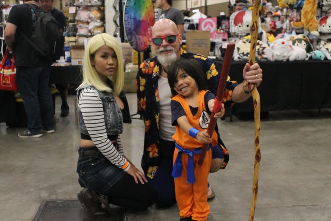 Madlyn Mendez and her son Eon pose with Ronie Kennedy dressed as Android 18, Kid Goku, and Master Roshi from “Dragon Ball.” [Jayme Lozano/A-J Media]