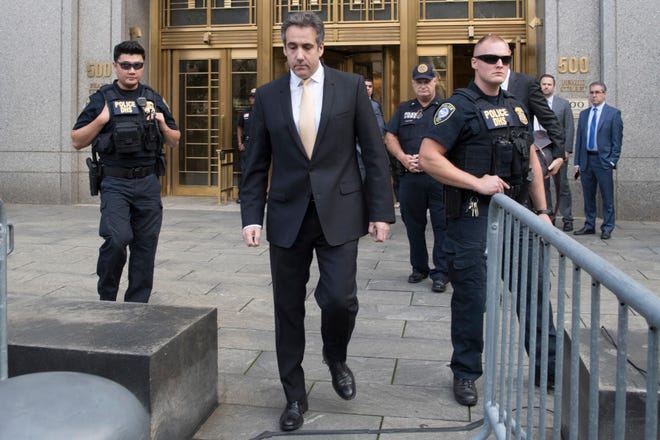 In this Aug. 21, 2018, photo, Michael Cohen, center, leaves federal court in New York. President Donald Trump has long demanded loyalty from his friends and associates. But he has been learning the hard way that in politics those relationships come and go. A key defection came this week when Cohen, Trump’s former personal attorney, implicated the president in a stunning plea deal, followed by a longtime friend and media boss cooperating with prosecutors. (AP Photo/Mary Altaffer)