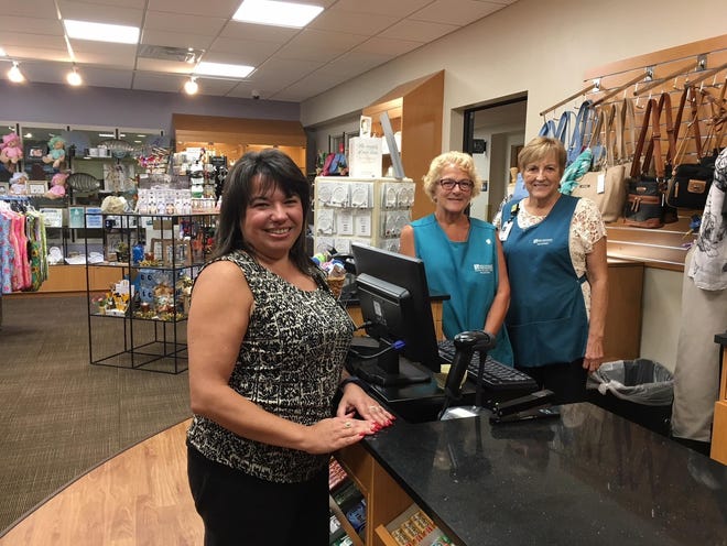 Shop Manager Nancy Cardoso stands at the counter of the Charlton Memorial Gift Shop with clerks Kathy McMann and Jeanne Cook ready to serve. [Photo by Deborah Allard/Herald News]