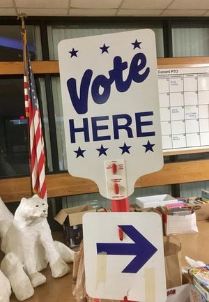 A "Vote Here" sign directs voters to the booths. State officials say voter fraud in Massachusetts is a practically non-existant.

[File Photo]