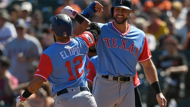 Rougned Odor (left) and Joey Gallo of the Rangers celebrate after Odor hit a three-run home run against the Giants in the eighth inning Saturday. THEARON W. HENDERSON/GETTY IMAGES