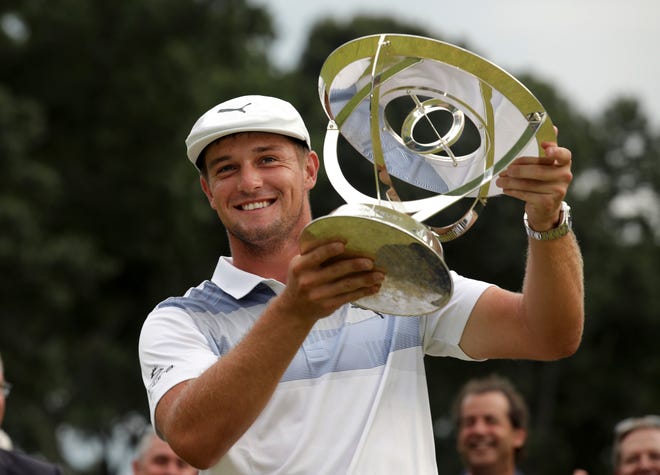 Bryson DeChambeau holds up the trophy after winning the Northern Trust tournament Sunday in Paramus, New Jersey. [Associated Press/Mel Evans]