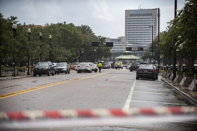 Police barricade a street near the Jacksonville Landing in Jacksonville, Fla., Sunday, Aug. 26, 2018. Florida authorities are reporting multiple fatalities after a mass shooting at the riverfront mall in Jacksonville that was hosting a video game tournament. (AP Photo/Laura Heald)