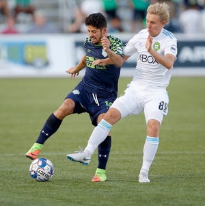 Oklahoma City's Jose Barril, left, fights for control with Seattle's Jesse Daley during a USL soccer game between Energy FC and the Seattle Sounders FC 2 at Taft Stadium in Oklahoma City on Saturday night. Barril set a franchise record in the game with ninth assist of the season. [PHOTO BY BRYAN TERRY, THE OKLAHOMAN]