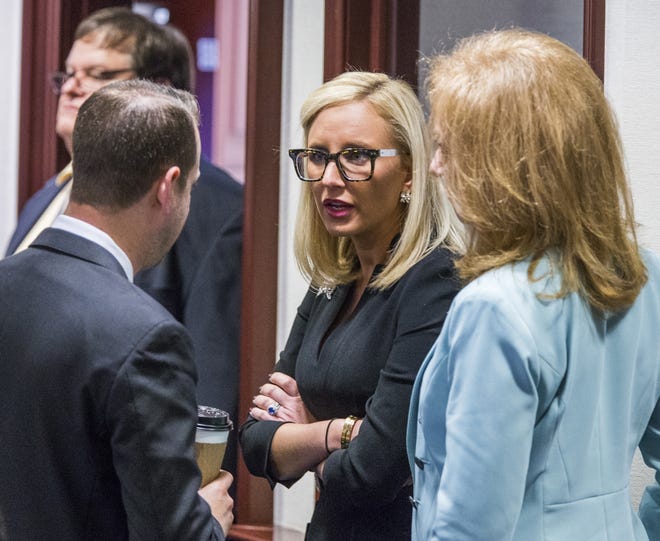 In this March 6 photo Florida Sen. Lauren Book, D-Plantation, center, speaks with Rep. Jared Even Moskowitz, D-Coral Springs, left, and Rep. Kristin Diane Jacobs, D-Coconut Creek, on the House floor in Tallahassee, Fla. The Florida legislative session was thrown into a chaotic final two weeks as lawmakers scrambled to pass a school safety bill in response to a shooting that killed 17 people at a Parkland high school. Book, whose constituents were affected by the shooting, said that's only partly to blame for the demise of sexual harassment legislation. She also cited "political games" and an "old boy" culture at the Capitol. [AP Photo/Mark Wallheiser, file]