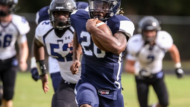 Dwyer’s #26 Ernest Blackshear outruns Park Vista defenders on his way to a touchdown during the first half at William T. Dwyer High School in Palm Beach Gardens on August 25, 2018. (Richard Graulich / The Palm Beach Post)