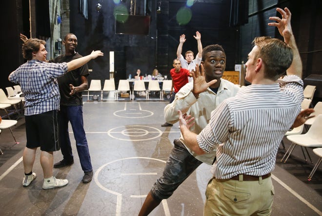 The cast of the play "Separate and Equal" rehearses in the Marian Gallaway Theatre at the University of Alabama Tuesday, Aug. 21, 2018. Adrian Baidoo guards Steven Bono Jr. as they play out a scene in an imagined basketball game between whites and blacks during the Jim Crow era in Birmingham. [Staff Photo/Gary Cosby Jr.]