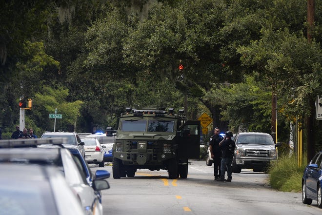 Savannah police's SWAT team surrounds a house on the 1100 block of East 53rd Street on Aug. 2. The department is planning to purchase drones to aid officers during barricaded gunman incidents, in addition to helping with traffic investigations and searches for missing people. [Will Peebles/Savannah Morning News]