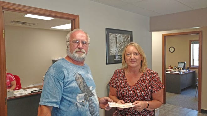 Tim Hemker Grand Knight for the Bronson council Knights of Columbus presents a check to Michelle LeTourneau from the Adapt Inc. in Coldwater. The check is the proceeds from the Bronson Knights of Columbus Tootsie roll drive in the amount of $586. We would like to thank everyone for their help with this drive.