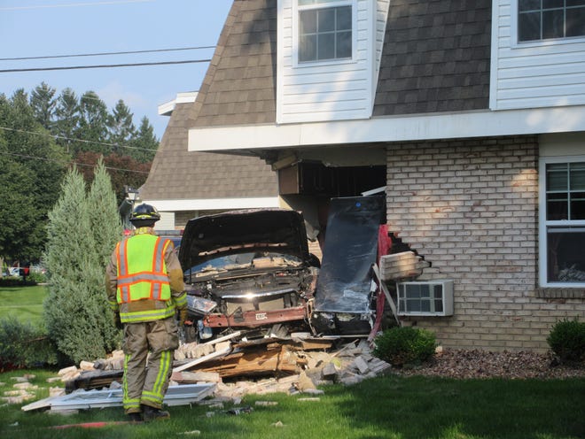 A car crashed into a corner apartment at Parklawn Apartments on Main Street in Honeoye late Sunday afternoon. [PHOTO PROVIDED]