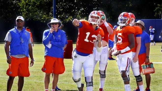 Florida quarterback Feleipe Franks (13) throws a pass under the eye of head coach Dan Mullen, left, and quarterbacks coach Brian Johnson during the team’s first practice of the fall with full pads on Aug. 7. Franks has been named the Gators’ starter at quarterback. (Brad McClenny/The Gainesville Sun)