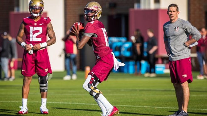 Florida State sophomore quarterback James Blackman looks to throw a pass during the first day of spring practice on March 21, 2018 in Tallahassee. Deondre Francois, Blackman's main competition for the starting quarterback job, is on the left and offensive coordinator Walt Bell is on his right. (Photo by Ross Obley)