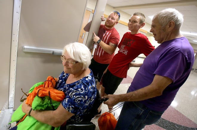 From left, physical education teacher Harley Price shows off the new gym to North Shelby student Donald Sigman, and parents Bobby and Cynthia at an open house on Friday. [Brittany Randolph/The Star]