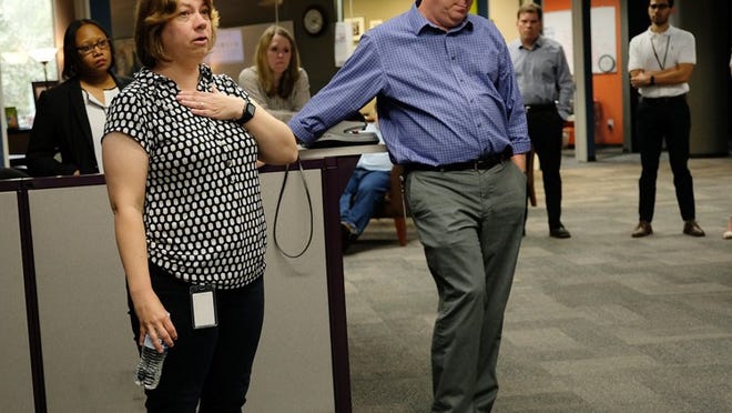Debbie Hiott announces that she will step down as editor of the American-Statesman as managing editor John Bridges and other staffers hear the news. NELL CARROLL / AMERICAN-STATESMAN