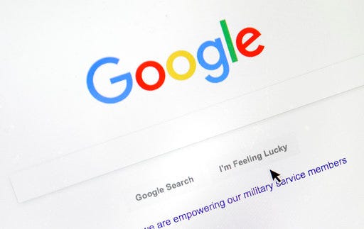 A cursor moves over Google's search engine page on Tuesday, Aug. 28, 2018, in Portland, Ore. Political leanings don’t factor into Google’s search algorithm. But the authoritativeness of page links the algorithm spits out and the perception of thousands of human raters do. (AP Photo/Don Ryan)