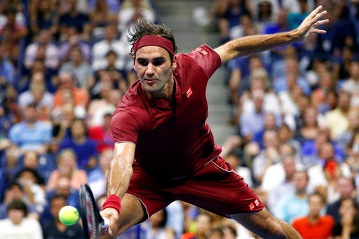 Roger Federer, of Switzerland, returns a shot to Yoshihito Nishioka, of Japan, during the first round of the U.S. Open tennis tournament, Tuesday, Aug. 28, 2018, in New York. (AP Photo/Adam Hunger)
