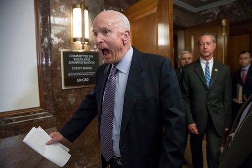 FILE - In this Oct. 25, 2017, file photo Senate Armed Services Chairman John McCain, R-Ariz., followed at right by House Armed Services Chairman Mac Thornberry, R-Texas, makes a humorous face to reporters on Capitol Hill in Washington. McCain died on Aug. 25, 2018, after battling brain cancer. McCain’s “wicked” wit was often aimed at himself over long Washington career. (AP Photo/J. Scott Applewhite, File)