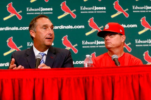 St. Louis Cardinals President of Baseball Operations John Mozeliak, left, answers questions after the team announced Mike Shildt, right, as manager, Tuesday, Aug. 28, 2018, at Busch Stadium in St. Louis. The St. Louis Cardinals have removed the interim tag from Mike Shildt's title, promoting him to manager after he led the team into postseason contention since taking over for the fired Mike Matheny. Shildt has guided the Cardinals to a 26-12 record since July 15 and they now hold the top spot in the National League wild card standings. (Christian Gooden/St. Louis Post-Dispatch via AP)