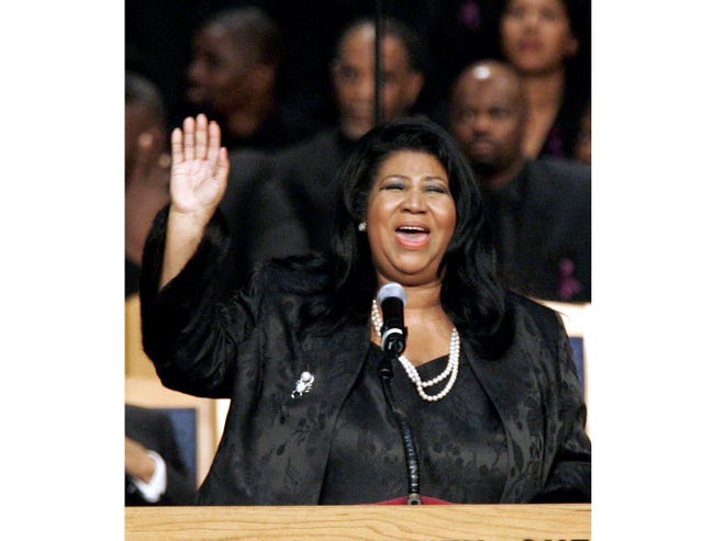 FILE-- In this Nov. 2, 2005 file photo, Aretha Franklin sings during the funeral for civil rights pioneer Rosa Parks at the Greater Grace Temple in Detroit. Franklin died Aug. 16, 2018 of pancreatic cancer at the age of 76. (AP Photo/Carlos Osorio)
