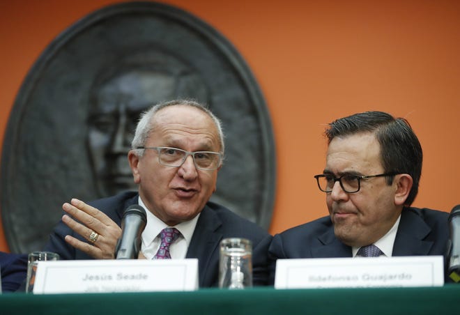 Jesus Seade, left, designated chief negotiator of Mexican President-elect Andres Manuel Lopez Obrador, gestures while speaking as Mexico's Secretary of Economy Ildefonso Guajardo, right, looks on during their news conference at the Mexican Embassy in Washington, Monday, Aug. 27, 2018. The Trump administration and Mexico have reached a preliminary accord to end the North American Free Trade Agreement and replace it with a deal that the administration wants to be more favorable to the United States. (AP Photo/Pablo Martinez Monsivais)