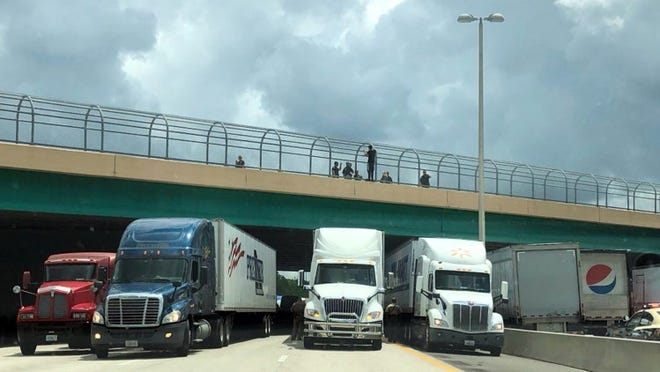Truckers stopped traffic on the Turnpike in Orlando by trying to help a man in Orlando who was threatening to jump.