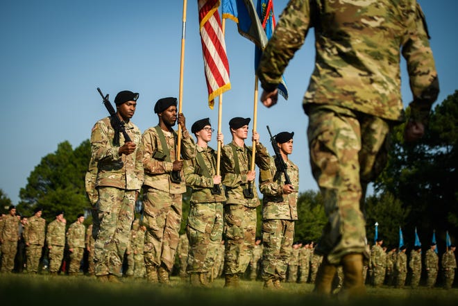 Col. Daniel Benick, right, walks toward the color guard to case the colors during the 525th Military Intelligence Brigade colors casing ceremony on Tuesday. More than 200 soldiers from the Fort Bragg-based unit will deploy to Afghanistan in the coming weeks. [Andrew Craft/The Fayetteville Observer]