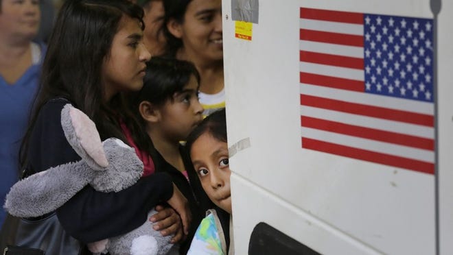 In this July 7, 2015, file photo, immigrants from El Salvador and Guatemala who entered the country illegally board a bus after they were released from a family detention center in San Antonio. Eric Gay / Associated Press