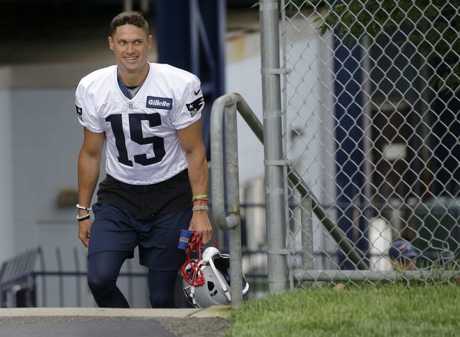 New England Patriots wide receiver Chris Hogan smiles as he steps on the field at the start of an NFL football practice, Thursday, July 26, 2018, in Foxborough, Mass. (AP Photo/Steven Senne)