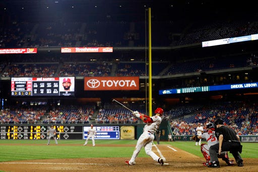 Philadelphia Phillies' Jose Bautista follows through after hitting an RBI-single off Washington Nationals relief pitcher Jimmy Cordero during the seventh inning of a baseball game Wednesday, Aug. 29, 2018, in Philadelphia. Philadelphia won 8-6. (AP Photo/Matt Slocum)