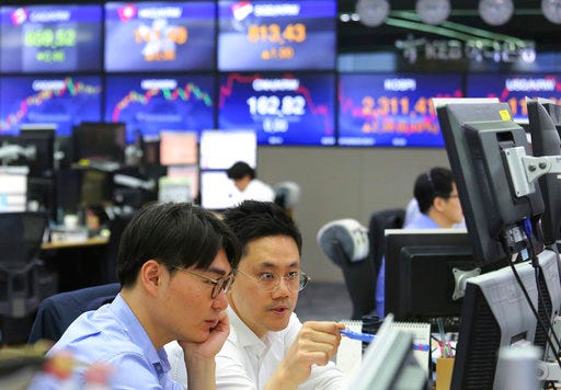 Currency traders watch monitors at the foreign exchange dealing room of the KEB Hana Bank headquarters in Seoul, South Korea, Thursday, Aug. 30, 2018. Asian markets were mixed Thursday as positive sentiment from U.S. economic data and the country's willingness to strike a trade deal with Canada was shaken by a weaker dollar. (AP Photo/Ahn Young-joon)