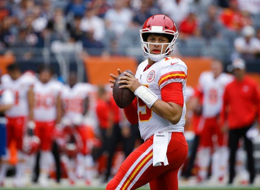 FILE - In this Aug. 25, 2018, file photo, Kansas City Chiefs' Patrick Mahomes looks for a receiver during the first half of the team's preseason NFL football game against the Chicago Bears in Chicago. The Chiefs’ first-round pick in last year’s draft, Mahomes is poised to begin his NFL quarterback career in earnest after the offseason trade of Alex Smith to Washington.(AP Photo/Annie Rice, File)