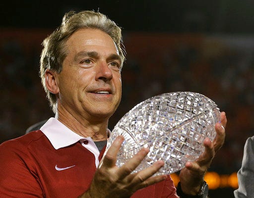 FILE - In this Jan. 7, 2013, file photo, Alabama head coach Nick Saban holds The Coaches Trophy after the BCS National Championship college football game against Notre Dame, in Miami. The decade-long chase to catch Alabama has caused patience to wear thin across the rest of the Southeastern Conference. As Nick Saban and Alabama chase their sixth national title in 10 seasons this year, five of the SEC’s other 13 programs have new coaches. It represents the league’s highest turnover since 1946, when the SEC had six new coaches. (AP Photo/David J. Phillip, File)