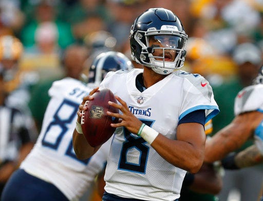FILE - In this Aug. 9, 2018, file photo, Tennessee Titans quarterback Marcus Mariota drops back during the first half of a preseason NFL football game against the Green Bay Packers in Green Bay, Wis. Mariota is going to get to run and throw more in an offense the Los Angeles Rams used to lead the NFL in scoring last season. Mariota is coming off his worst season, having thrown more interceptions (15) than touchdowns (13). But he enjoyed a rehab-free offseason and looks faster playing without a knee brace. (AP Photo/Matt Ludtke, File)