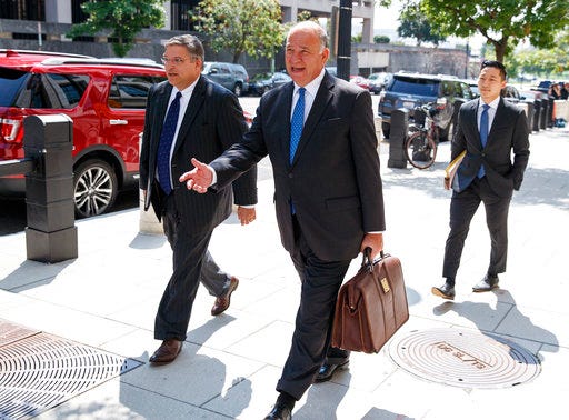 Richard Westling, left, and Thomas Zehnle, center, with the defense team for Paul Manafort, leave federal court in Washington, Tuesday, Aug. 28, 2018, after previewing of cases as they argue over how much jurors will be allowed to hear of the former Trump campaign chairman's lengthy foreign lobbying career. (AP Photo/Carolyn Kaster)