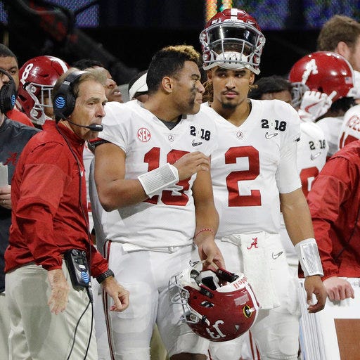 FILE - In this Jan. 8, 2018, file photo, Alabama quarterbacks Jalen Hurts (2) and Tua Tagovailoa (13) and head coach Nick Saban watch from the sideline during the second half of the NCAA college football playoff championship game against Georgia in Atlanta. (AP Photo/David J. Phillip)