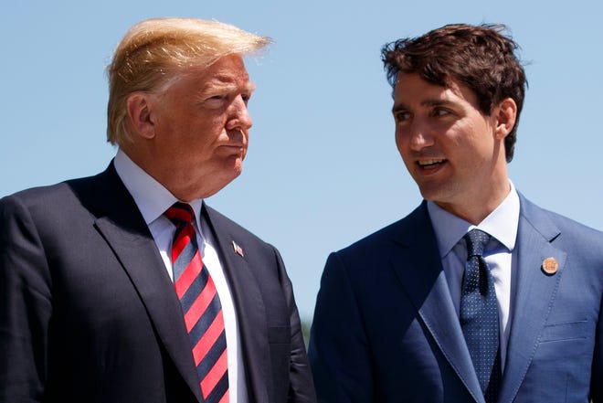 FILE - In this June 8, 2018, file photo, President Donald Trump talks with Canadian Prime Minister Justin Trudeau during a G-7 Summit welcome ceremony in Charlevoix, Canada. Canadians are stunned by the repeated broadsides from what had long been their closest ally and some have even begun boycotts. It started with Trump's attacks on Canadian dairy farmers, then Washington slapped tariffs on Canadian steel, citing national security. Then it was a disastrous G-7 Summit in Quebec and now it's a new North American free trade agreement without the northern tier of the continent. (AP Photo/Evan Vucci, File)