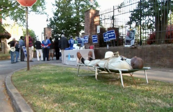 FILE - In this Tuesday, April 17, 2018, file image from video provided by KTHV-TV, Pulaski County Circuit Judge Wendell Griffen lies on a cot outside the Arkansas governor's mansion in Little Rock during a death penalty protest. A federal appeals court on Wednesday, Aug. 29, 2018, says it won't revive Griffen's lawsuit challenging his disqualification from execution cases over his participation in the anti-death penalty demonstration. (KTHV/TEGNA Inc. via AP, File)