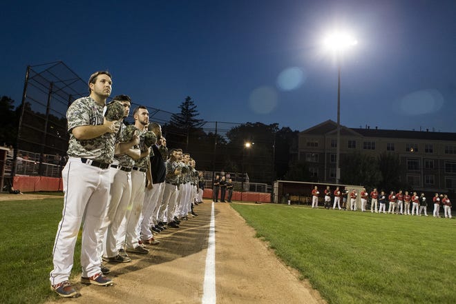 The Lexington Blue Sox stand for the National Anthem before game two of the Intercity League baseball playoffs at Morelli Field in Melrose on Aug. 24, 2018. The Lexington Blue Sox defeated Watertown 6-1 on Friday and went on to win their 14th Intercity League title on Sunday. [Wicked Local Staff Photo/Ruby Wallau]