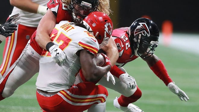 Falcons safety Keanu Neal, right, is called for a helmet penalty for 15 yards hitting Chiefs running back Kareem Hunt with defensive end Brooks Reed during a NFL preseason game earlier this month. (Curtis Compton/Atlanta Journal-Constitution/TNS)