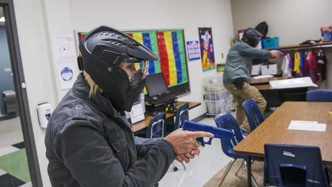 Prospective school marshals demonstrate a training exercise with simulated firearms at Pflugerville’s Windermere Elementary School on Aug. 10. AMANDA VOISARD / AMERICAN-STATESMAN