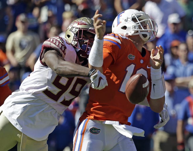 Florida State defensive end Brian Burns (99) strips the ball from Florida quarterback Feleipe Franks (13) during a game on Nov. 25, 2017, in Gainesville. Franks threw three interceptions in the loss. [AP Photo/John Raoux, File]