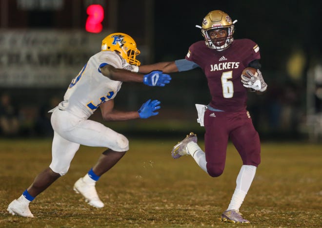 St. Augustine Michael Early (6) stiff-arms Palatka Kdarious Poole (30) during a 2017 game. [Gary Lloyd McCullough, For the St. Augustine Record]