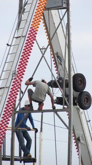 CDAC workers put up the Ferris wheel — the carnival's biggest attraction — on Tuesday in Kewanee in preparation for Hog Days.

Mike Helenthal/GateHouse Media Illinois