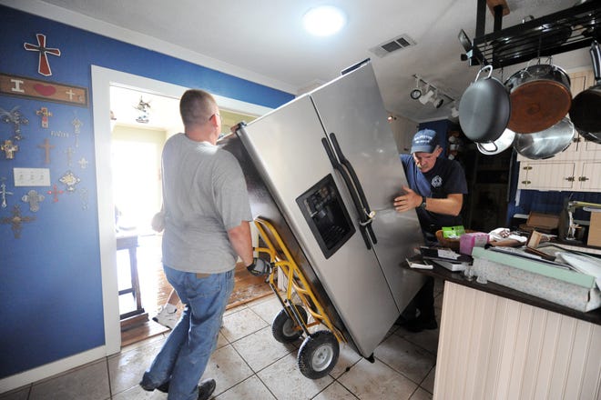Moving a fridge requires careful preparation, protection, and aftercare to avoid damaging any delicate components. [By Jocelyn Augustino (This image is from the FEMA Photo Library.) [Public domain], via Wikimedia Commons]
