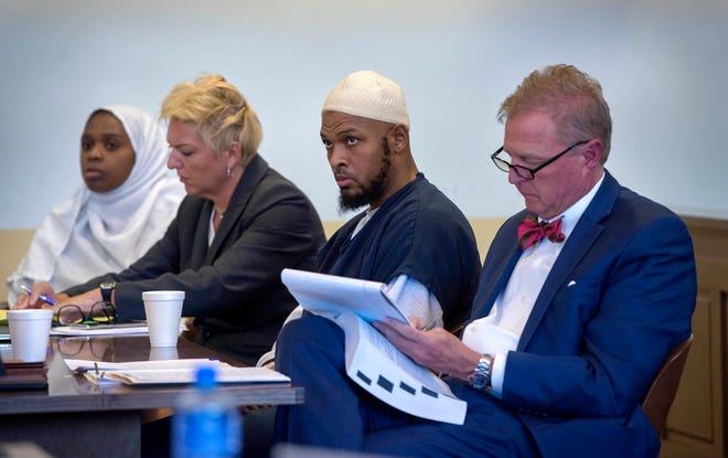 Jany Leveille, from left, with her attorney Kelly Golightley, and Siraj Ibn Wahhaj with attorney Tom Clark listen to the prosecutor during a hearing on a motion to dismiss in the Taos County Courthouse, Wednesday, Aug. 29, 2018. Judge Jeff McElroy ordered lesser charges of neglect against both defendants dropped as the result of a deadline missed by prosecutors. (Eddie Moore/The Albuquerque Journal via AP, Pool)