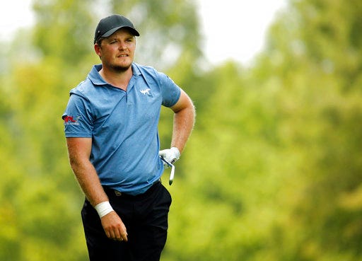 FILE - In this Sunday, Aug. 12, 2018 file photo, Eddie Pepperell, of England, watches his shot from the fifth fairway during the final round of the PGA Championship golf tournament at Bellerive Country Club, in St. Louis. Thorbjorn Olesen, Eddie Pepperell and Matthew Fitzpatrick are bidding to become the eighth automatic member of a Ryder Cup Europe team seeking to regain the cup from the United States in Paris this September. (AP Photo/Charlie Riedel, File)
