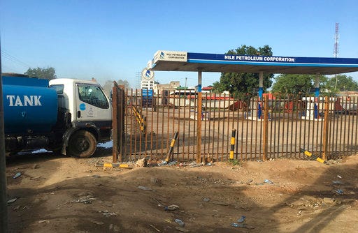 FILE - In this Sunday Oct. 1, 2017 file photo, a truck waits outside a closed petrol station of the Nile Petroleum Corporation in Juba, South Sudan. South Sudan says it will resume oil production in a key region in September 2018 to make up for more than $4 billion of revenue lost during years of fighting. (AP Photo/Sam Mednick, File)