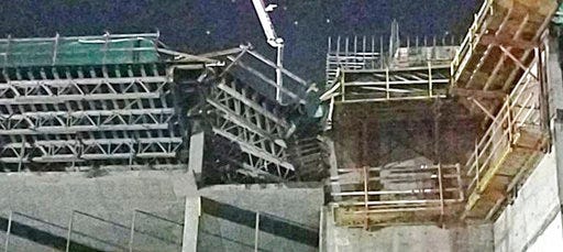 This shows the collapsed scaffolding, center, at a hotel under construction after two workers fell to their deaths early Wednesday, Aug. 29, 2018, near Orlando, Fla. (Orange County Fire Rescue via AP)