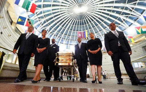 The casket of legendary singer Aretha Franklin is moved from the Charles H. Wright Museum of African American History in Detroit, Wednesday, Aug. 29, 2018. Franklin died Aug. 16, 2018 of pancreatic cancer at the age of 76. (AP Photo/Paul Sancya)